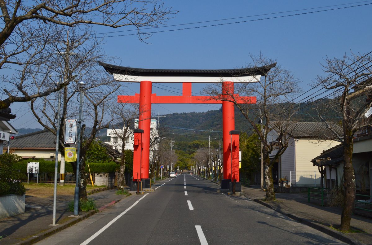 The large red torii standing over the road that leads to Kagoshima Jingu.